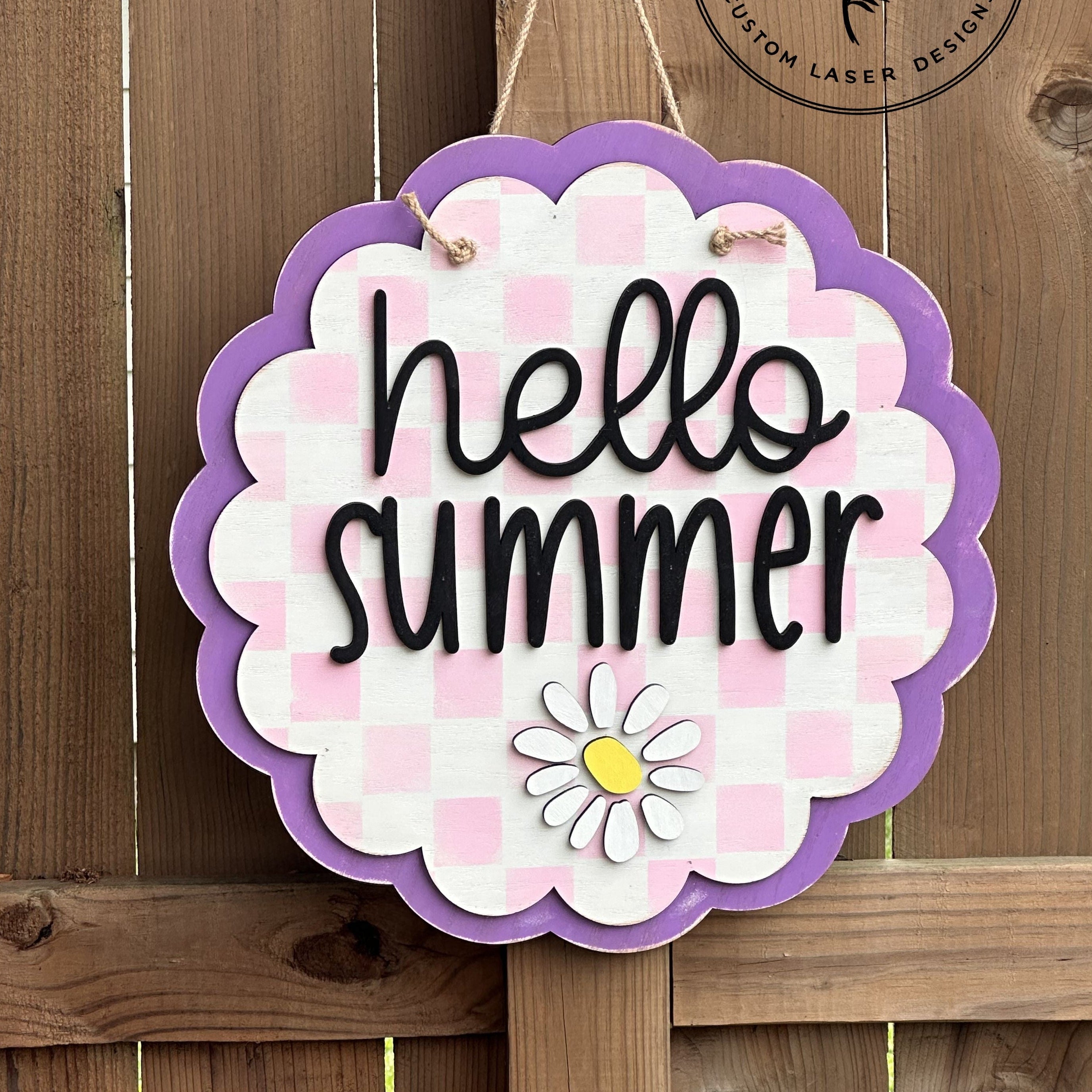 Decorative sign with 'hello summer' text on a wooden background